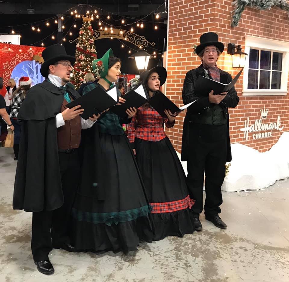 The Village Carolers singing at ChristmasCon