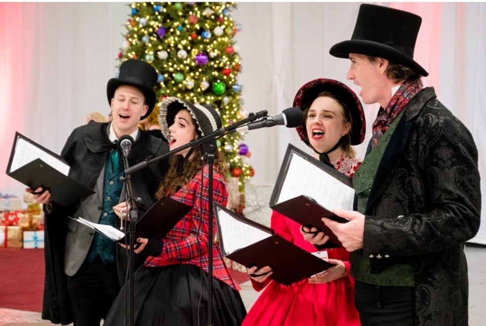 The Village Carolers singing at ChristmasCon